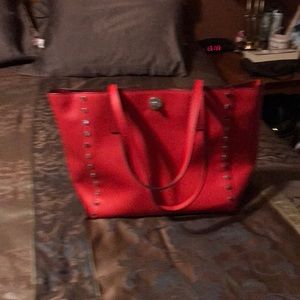 Red Michael Kors bag with clean bag